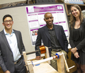 Students standing around an engineering device